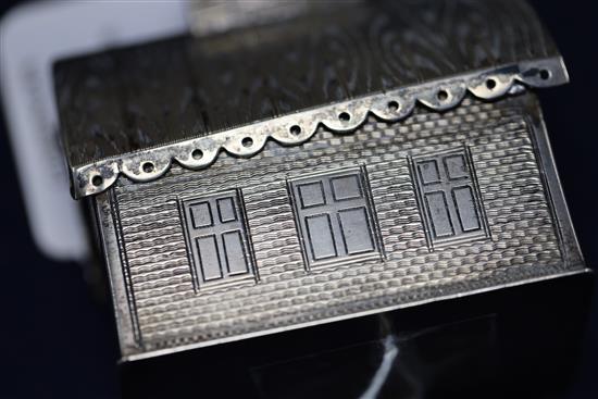 A 19th century Russian silver money box modelled as a dacha, with engraved decoration, coin slot to chimney, KB initials